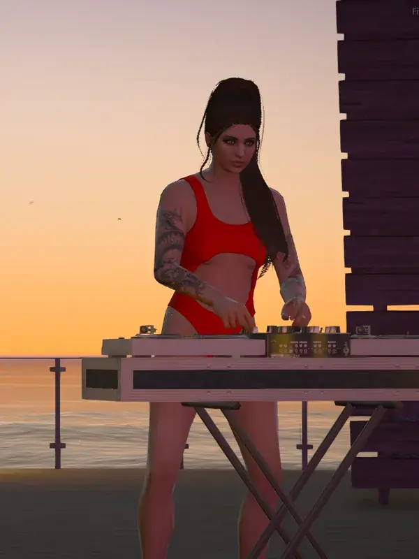 A DJ playing a set on a pier deck at sunset