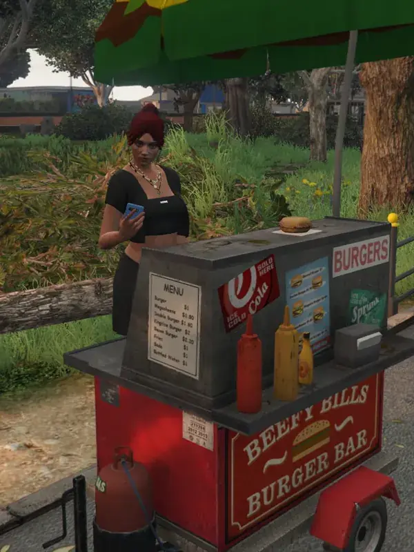 A woman checks her phone behind a red roadside burger cart in Paleto Bay